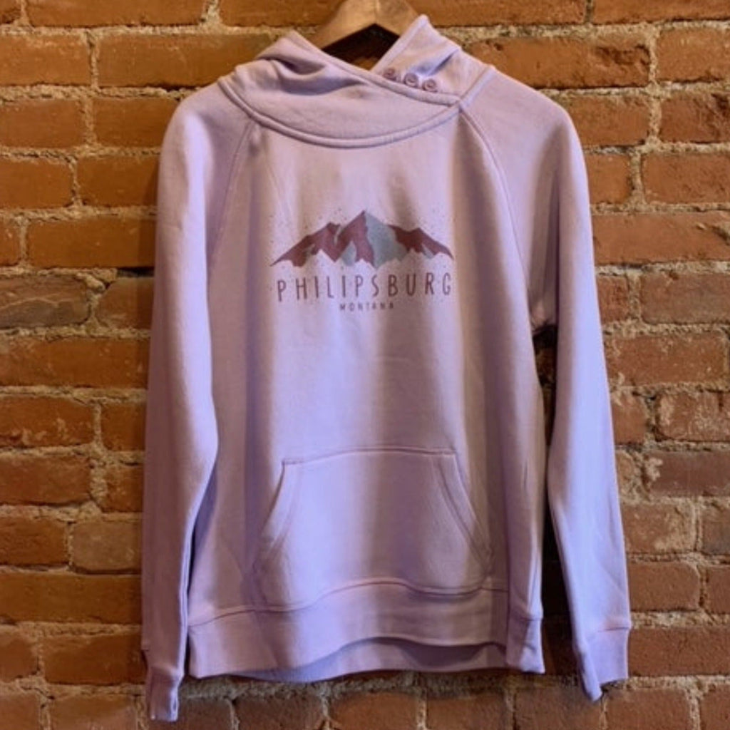Picture of Ouray womens turtleneck sweatshirt. The front shows off a kangaroo pocket, criss crossed turtleneck with buttons, and thumbholes. The print on the front features purple mountains, with the text "Philipsburg Montana." 
