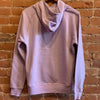 Picture of the back of the women's turtleneck sweatshirt. The  back features a hood.