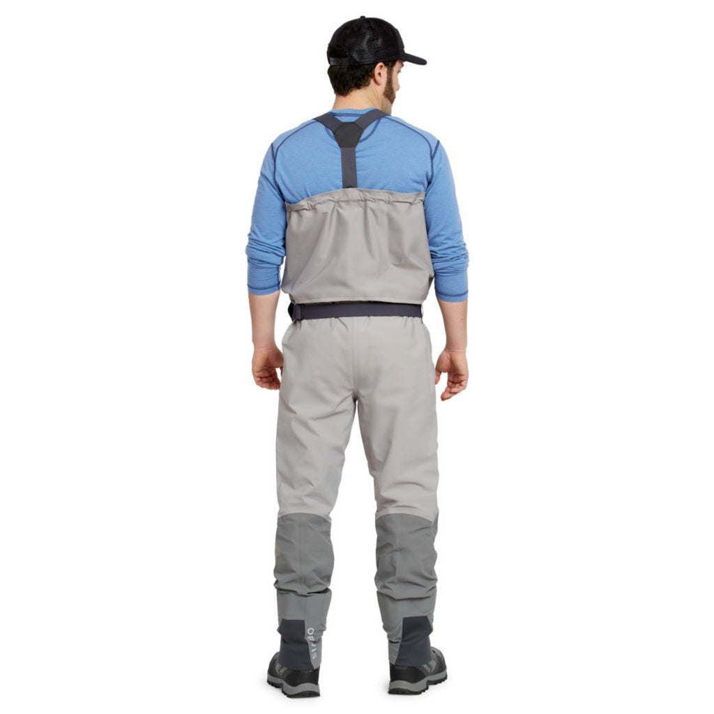 man showing back of orvis ultralight convertible waders