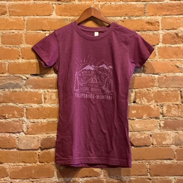 Front of Ouray women's crew neck short sleeve tee in the colorway Velvet Heather (dark magenta). The logo "When in doubt, take the scenic route. Philipsburg Montana" is printed in a light purple ink. The text is scattered around a river mountain scene in the same color ink.