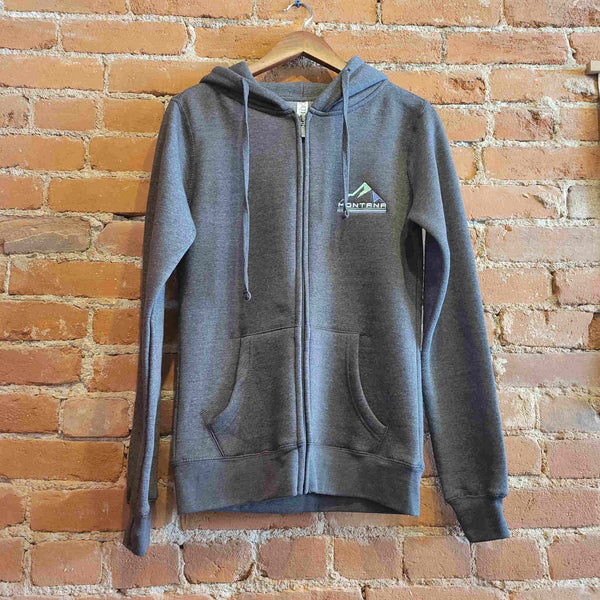 Front of Ouray women's hoody, drawstrings match the Graphite colorway of the hoody. There are thumbholes, a kangaroo pocket and zipper down the front.  There is  an embroidered "Montana" logo under blue mountains.