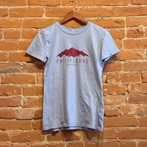 Front of Ouray women's mineral wash crew neck tee in the colorway Blue Fog (light blue). The Logo "Philipsburg Montana" is printed in red text below red mountains.